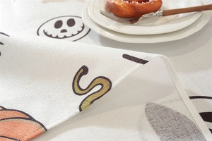 Detailed close-up of Halloween tablecloth showing pumpkin motifs and woven texture