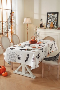 Detailed pattern of Halloween tablecloth with pumpkins, bats and ghosts on white fabric