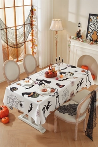 Detail of Halloween tablecloth with bat and pumpkin patterns on a dining table
