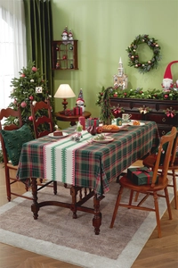 Detailed Christmas table runner with red plaid and festive tree patterns on a wooden table