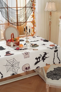 Detailed close-up of Halloween tablecloth with bat, pumpkin and ghost festive prints