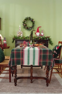 Close-up of Christmas table runner featuring red plaid and festive tree patterns