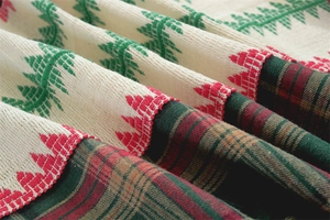 Close-up of thick woven Christmas table runner fabric with red and green plaid patterns