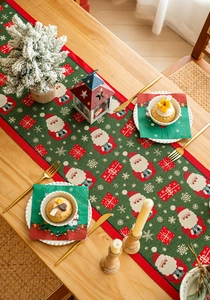 Close-up of yarn-dyed jacquard table runner with festive Santa and snowflake patterns
