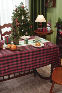Close-up of red and black buffalo plaid Christmas table runner with white hollow lace