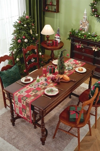 Close-up of Christmas table runner with red and green plaid patterns and pompom tassels