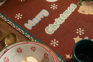 Detail of Christmas table runner with Merry Christmas jacquard weave and snowflake patterns