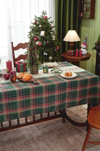 Classic red and green plaid Christmas tablecloth on a festive dining table setup