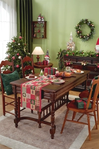 Close-up of festive Christmas table runner with red and green reindeer jacquard pattern