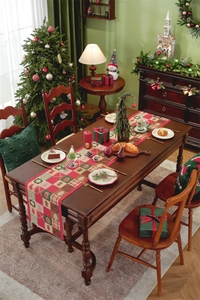 Detail of Christmas tree jacquard table runner on a wooden table with festive decor