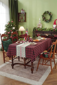 Detailed texture of red and black buffalo plaid tablecloth with ethnic embroidery pattern