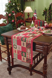 Close-up of festive Christmas table runner featuring jacquard pine trees and geometric patterns
