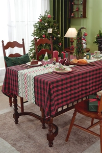 Detail of red and black plaid Christmas table runner with white geometric jacquard pattern