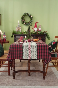 Detail of red and black plaid Christmas table runner with ethnic woven embroidery