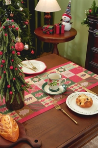 Close-up of woven Christmas table runner with Nordic snowflakes and holiday tree patterns