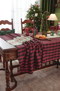 Close-up of red plaid Christmas table runner with crochet lace on wooden table