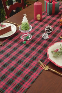 Detail of red and green plaid Christmas table runner with golden silk jacquard texture