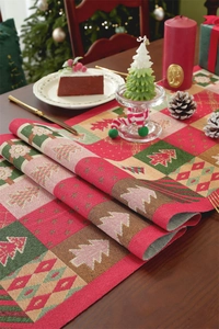 Detail of Christmas table runner with festive patchwork patterns and jacquard texture