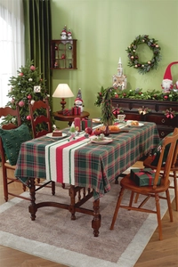 Detailed view of festive plaid Christmas table runner and tablecloth for holiday decor
