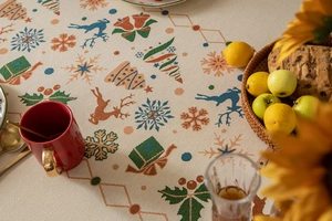 Detail of Christmas tablecloth showing woven reindeer and snowflake patterns