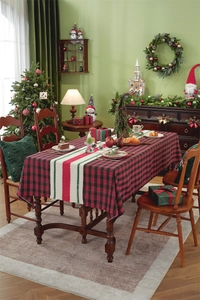 Close-up of buffalo plaid Christmas table runner with festive evergreen tree pillows