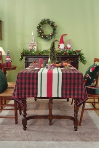 Close-up of red and black buffalo plaid tablecloth with striped festive table runner