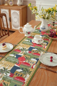 Exotic Middle East table runner with woven castles and palm trees on a wooden dining table