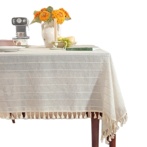 Beige linen rectangular tablecloth with textured stripes and elegant tassel fringe