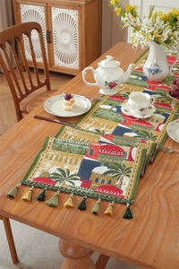 Close-up of jacquard table runner with Mediterranean patterns and colorful tassels