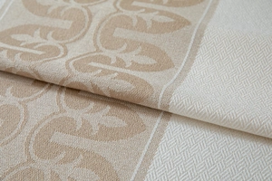 Macro view of jacquard weave fabric with elegant beige leaf patterns and texture