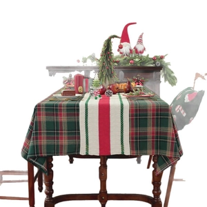 Christmas table runner with red and green plaid patterns on a festive holiday dinner table