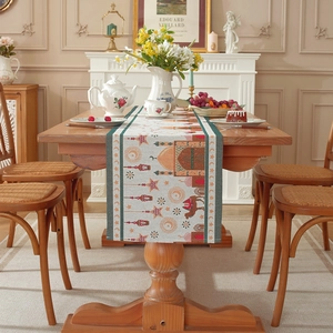 Detail of Eid Mubarak table runner featuring jacquard mosque and camel pattern with tassels