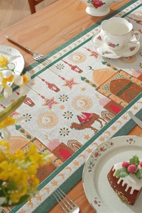 Detail of Ramadan table runner with mosque, moon and camel pattern on wooden table