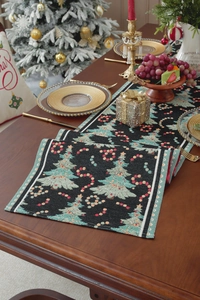 Detailed jacquard Christmas table runner with festive tree patterns on dark wooden table