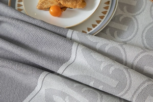 Macro shot of grey jacquard wave tassel tablecloth with high-end geometric patterns