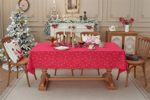 Detail of red Christmas tablecloth with golden snowflake and reindeer patterns