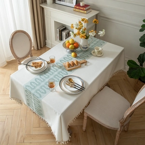 Off-white jacquard tablecloth with green vine patterns and elegant tassel edges
