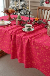 Detail of red Christmas tablecloth with festive golden bell and snowflake pattern