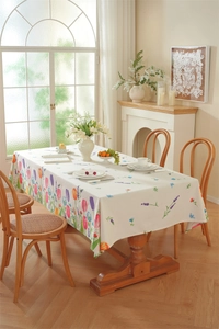 Detailed view of floral printed rectangular tablecloth with fringes and tulip patterns