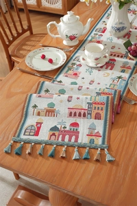 Detail of Middle East style table runner with colorful castle prints and woven tassels