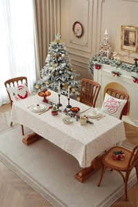 Close-up of festive cream tablecloth with golden snowflake patterns for Christmas dining