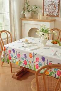 Detailed close-up of tulip floral prints and decorative tassels on cotton blend tablecloth