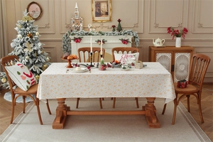 Detail of festive rectangular tablecloth with golden Christmas snowflake patterns