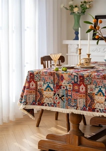 Macro detail of bohemian jacquard tablecloth with ethnic patterns and cream tassels