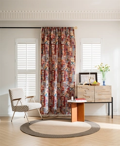 Detail of Bohemian curtain fringe with colorful jacquard pattern in a bright living room