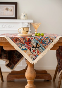 Close-up of bohemian woven table runner with geometric patterns and fringe edges