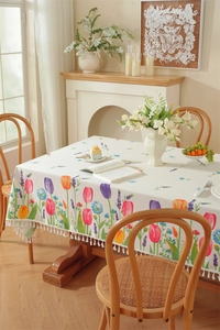 Detailed close-up of colorful tulip print fabric with elegant white tassel fringe edges