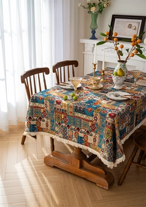 Detailed close-up of Bohemian jacquard tablecloth featuring blue floral patterns and white fringe