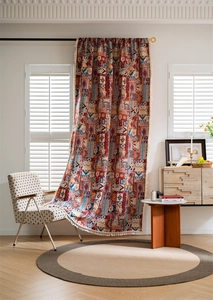 Detail of bohemian jacquard curtain featuring ethnic prints and white woven tassels