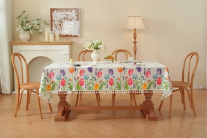 Detailed view of tulip prints and white tassels on a rectangular cotton table runner